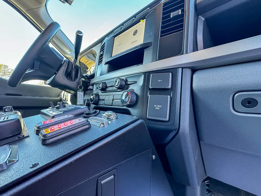 Front center console close-up with radios, control knobs, and dashboard switches.