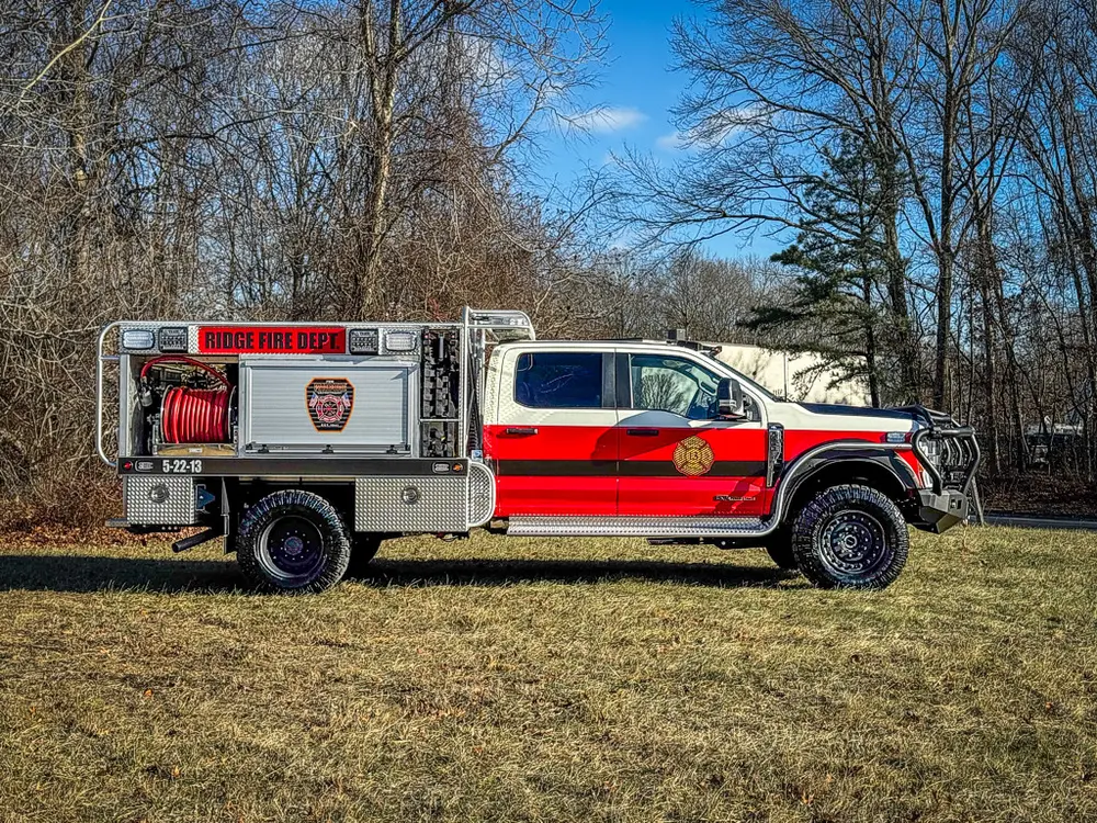 Full left-side profile of the truck parked on grass.
