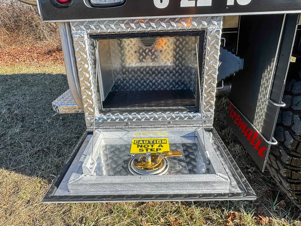 Open lower side compartment with fold-down tray and empty interior.