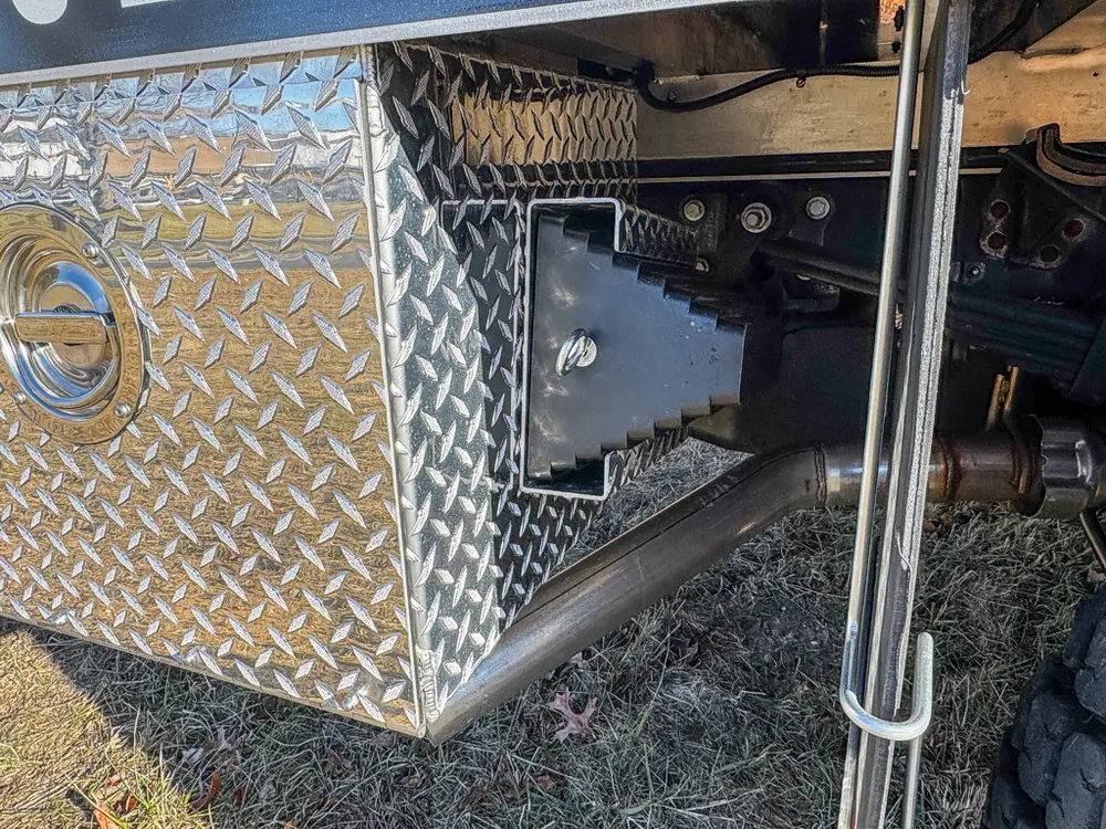 Small side access compartment open with mounted electrical hardware.