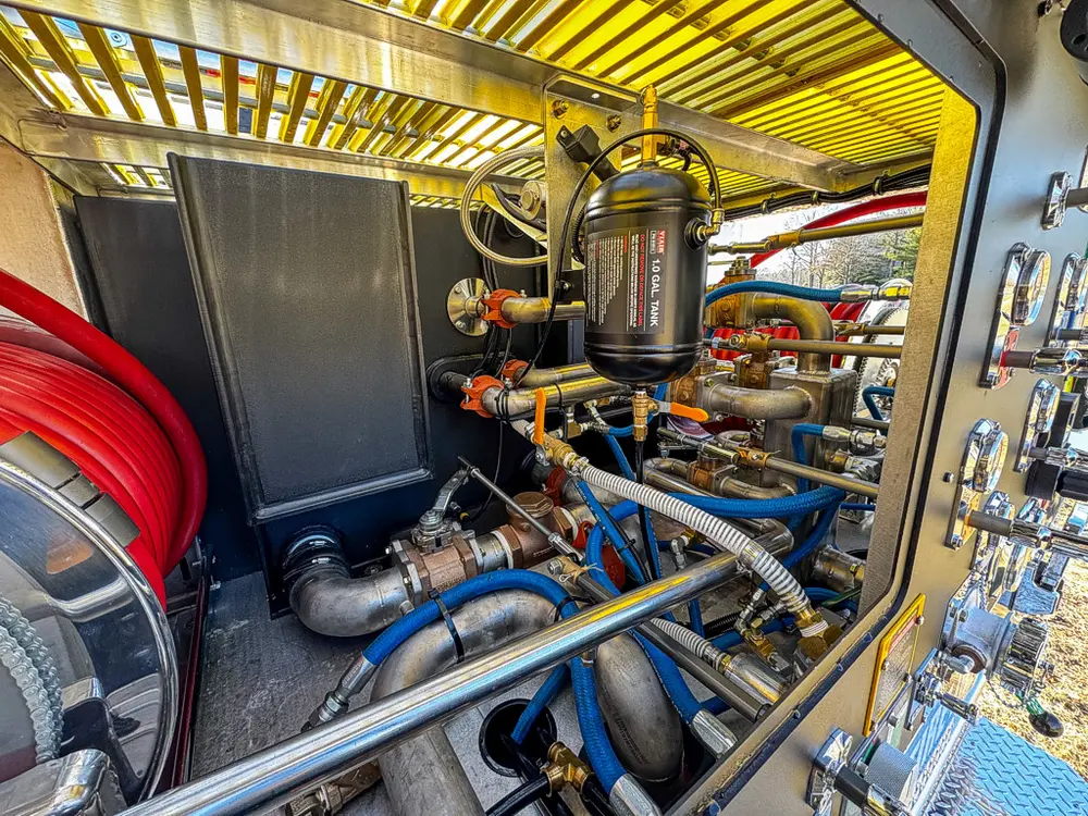 Pump compartment interior showing hoses, valves, and piping.