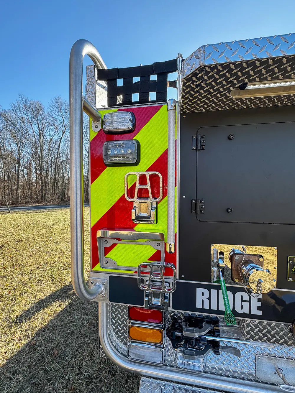Rear corner close-up with chevron striping, lighting, and panel edge.