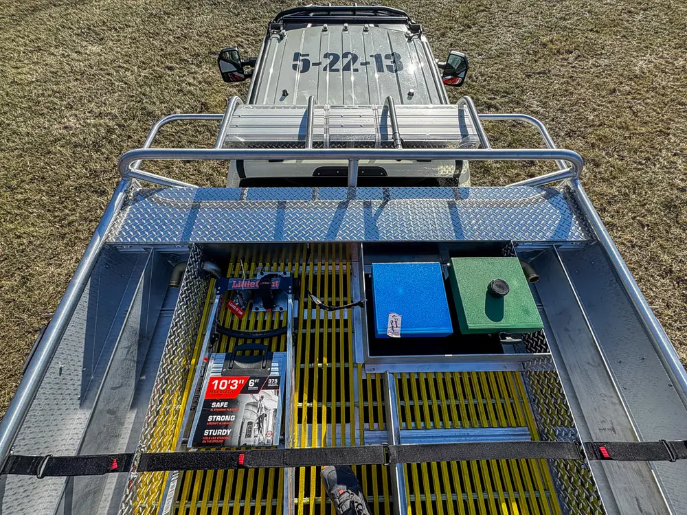 Top-down view over the rear deck with equipment compartments and rails.