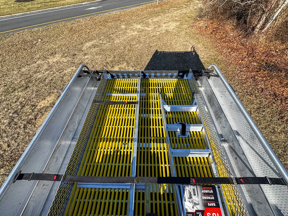 Top-deck close-up showing grated walkway sections and mounted components.