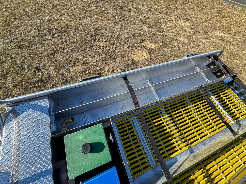 Upper side-deck view with yellow grating and equipment box lids.