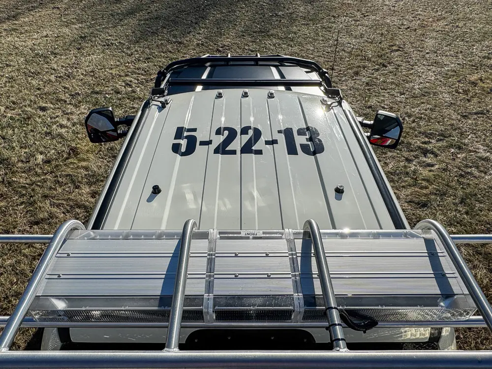 Top view toward the cab roof showing front deck rails and number marking.