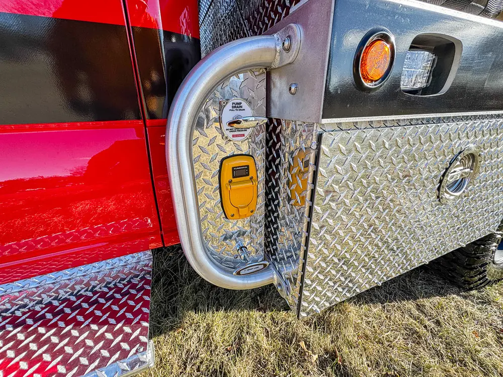 Open small body compartment door with latch hardware and marker light.