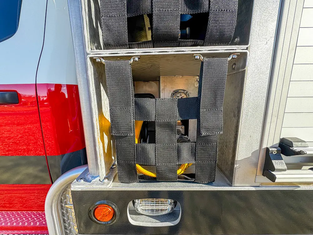 Open narrow vertical compartment with interior mounting brackets.