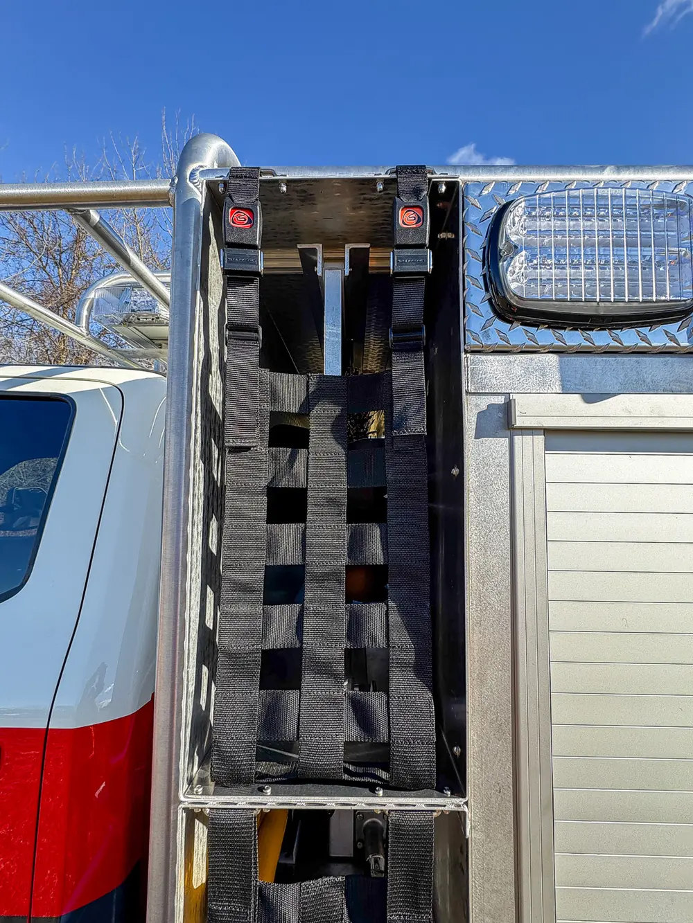 Open vertical side compartment showing rack-style equipment mounts.