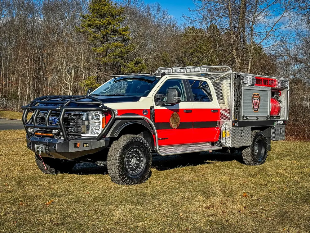Front-left exterior view with brush guard and side body visible.