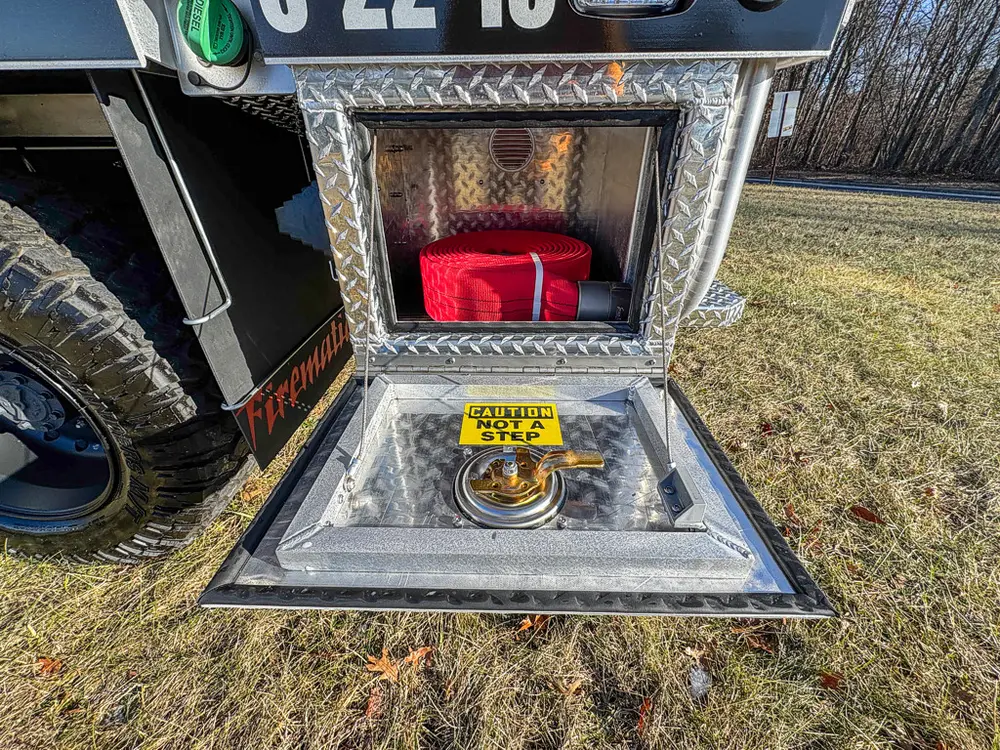 Open lower compartment showing a red strap bag on the floor.