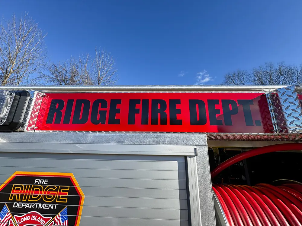 Side body close-up with fire department text above the roll-up door.