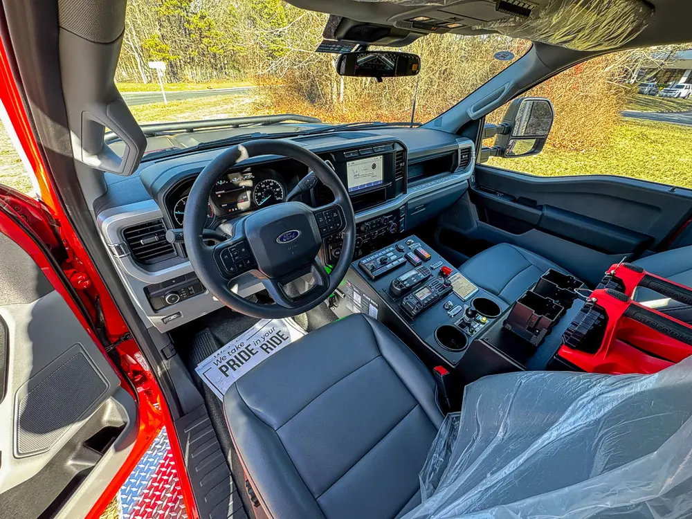 Wide front-cab interior view from the passenger side.
