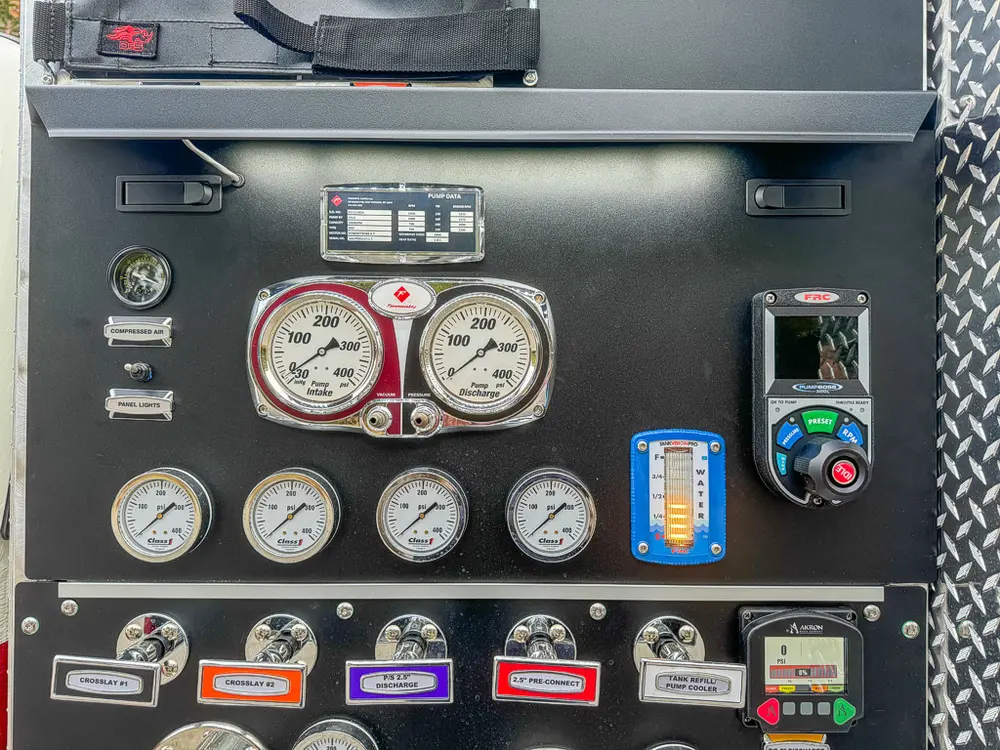 Pump control close-up with pressure gauges and engine control module.