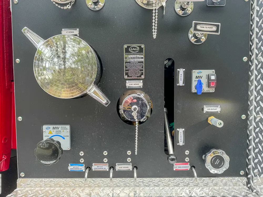 Upper pump panel close-up with intake cap and auxiliary controls.