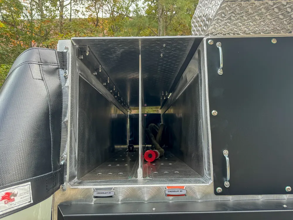 Open side compartment behind wheel with deep storage bay.