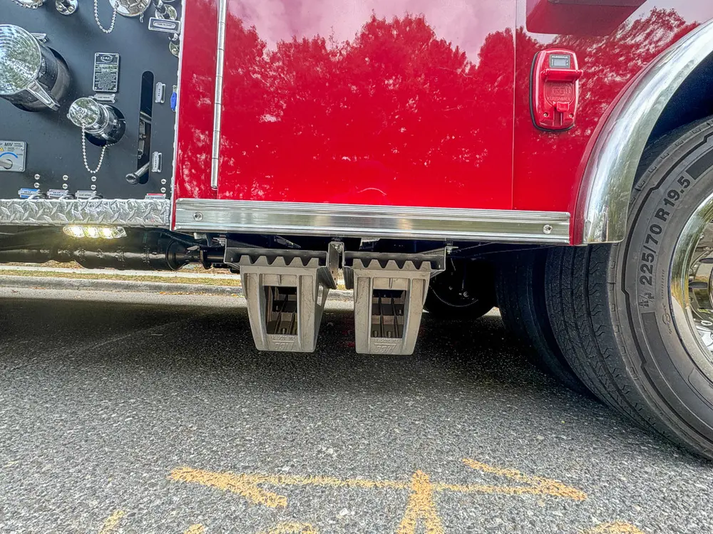 Lower side body close-up with fold-out step under compartment.