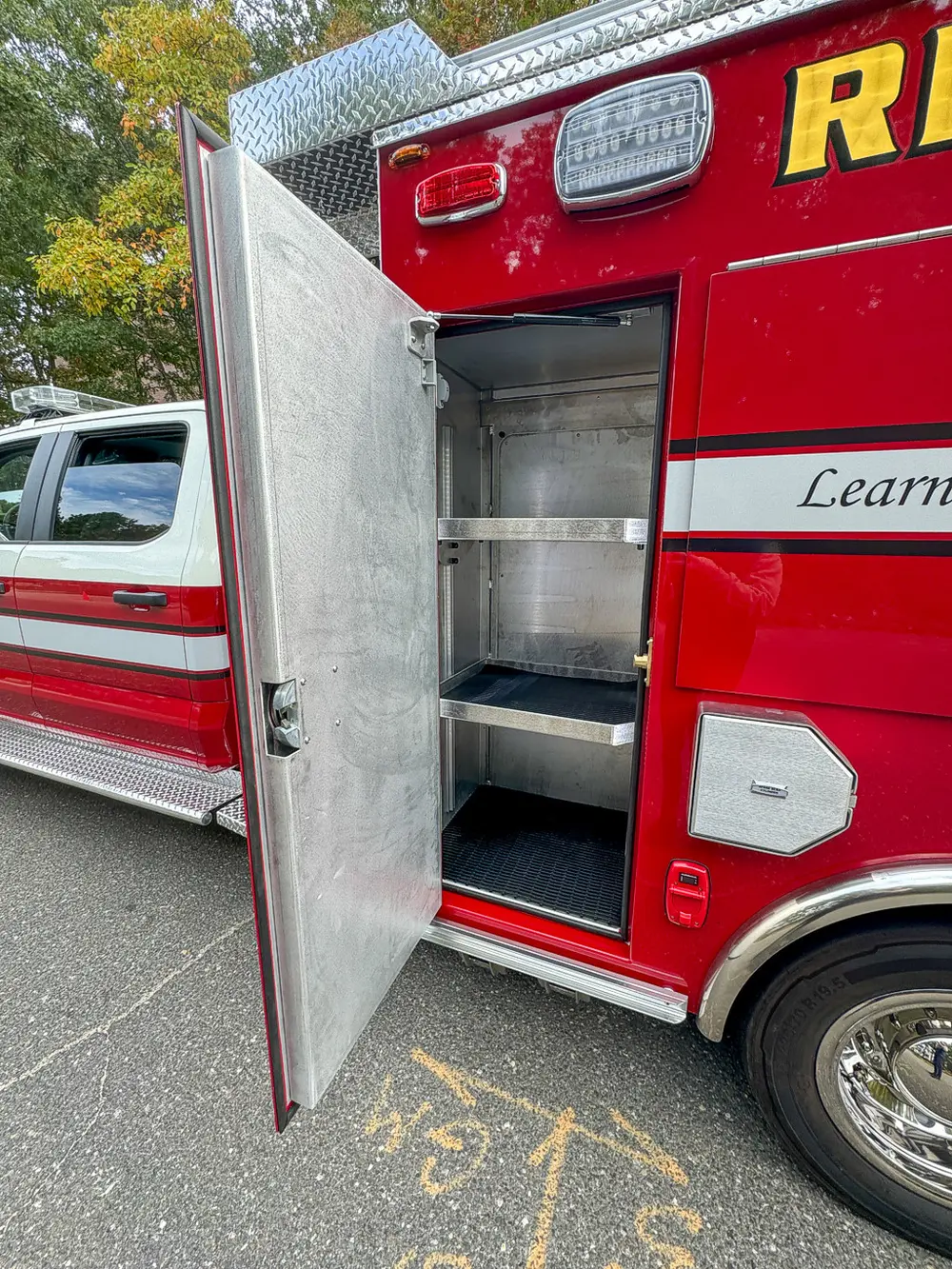 Open vertical side compartment with shelf and empty storage.