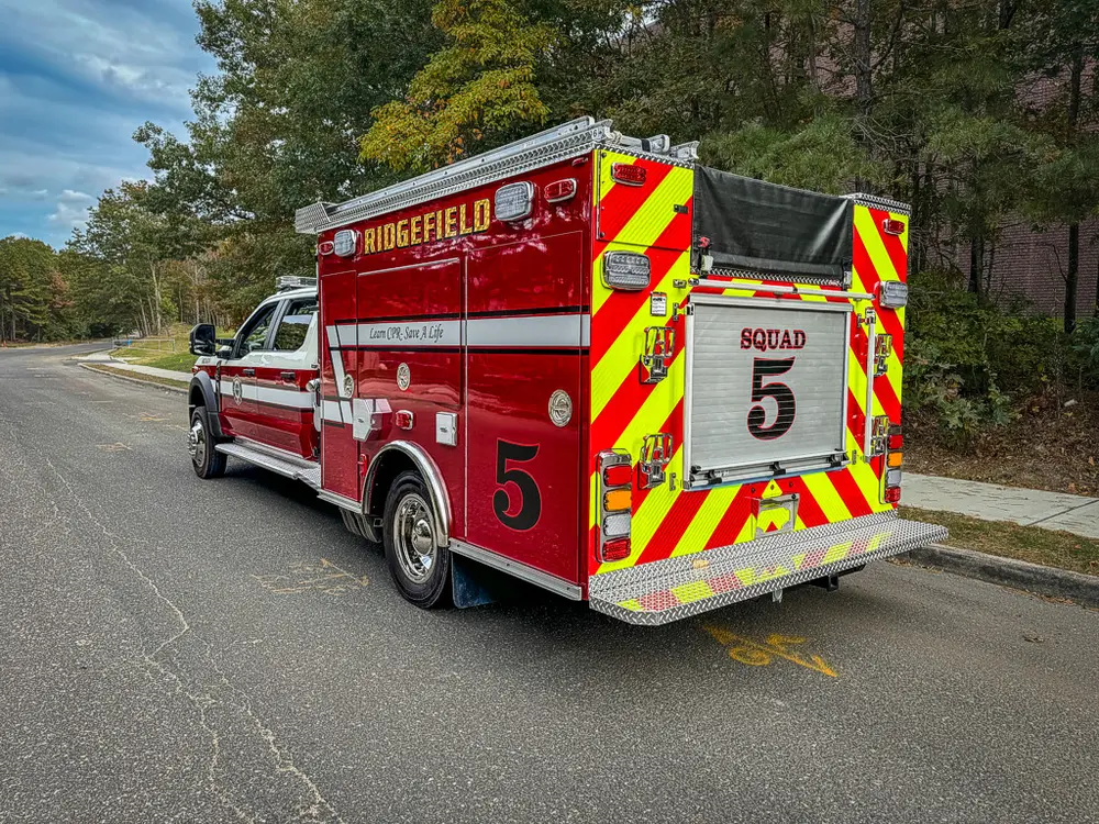 Rear-left three-quarter view with chevron rear panel visible.