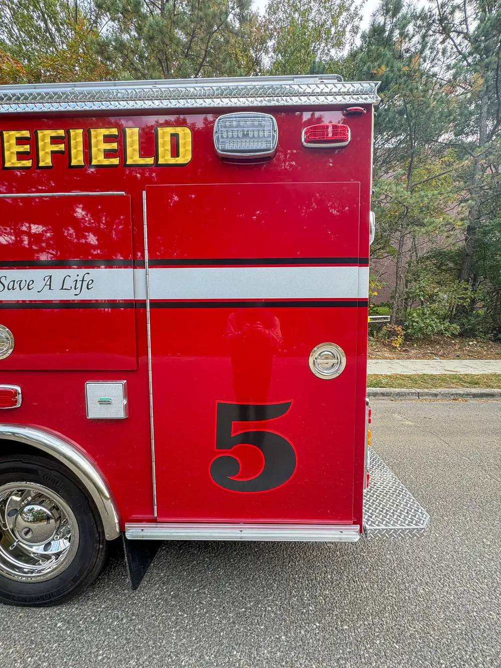 Side body section with lettering and large number 5 graphic.