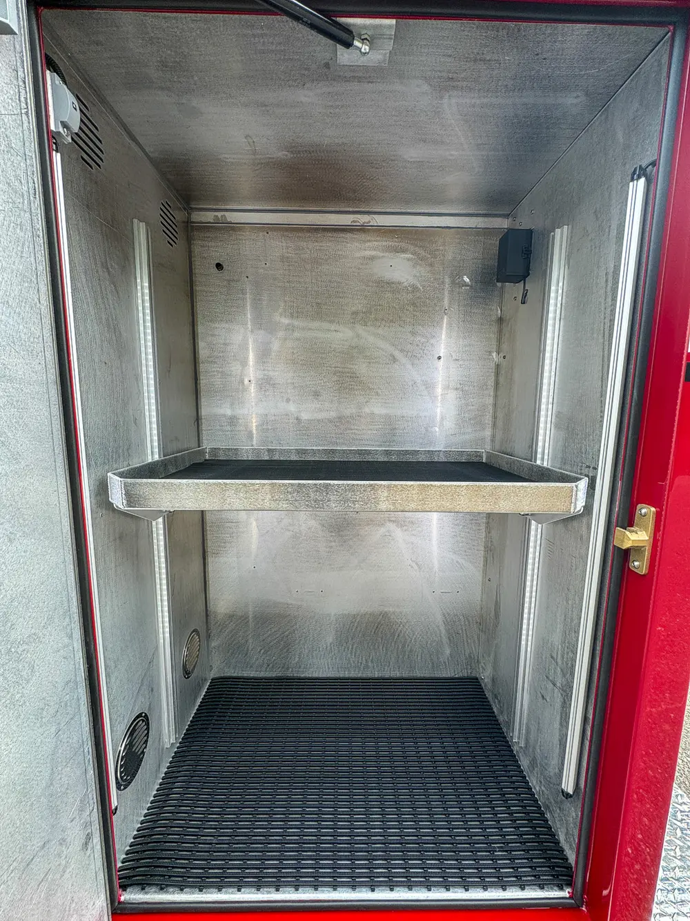 Compartment shelf close-up with empty storage bay.