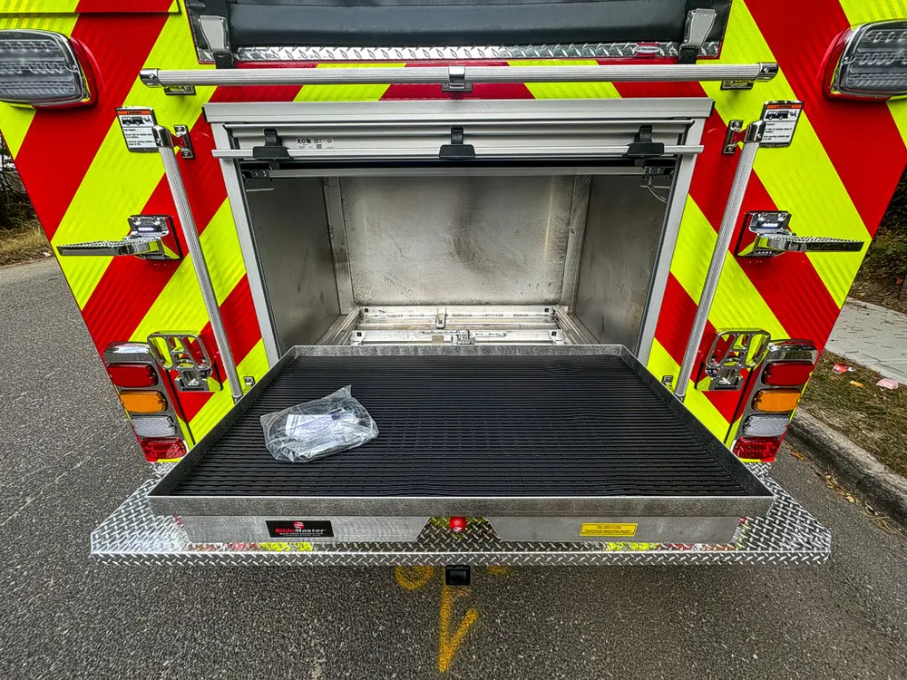 Rear compartment open wide with deep interior and lower tray.