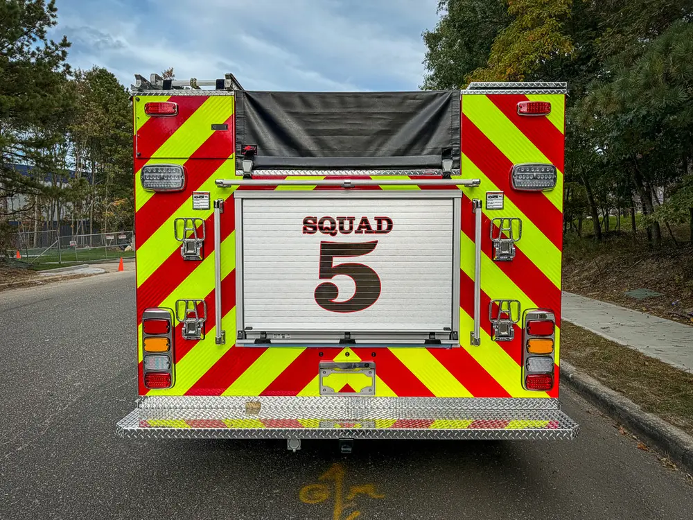 Straight rear view with Squad 5 roll-up door and chevrons.