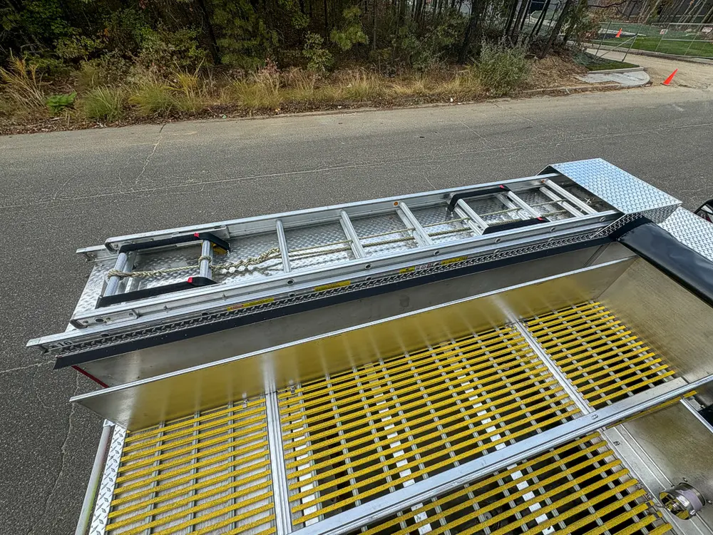 Top deck close-up with ladder resting over grating.