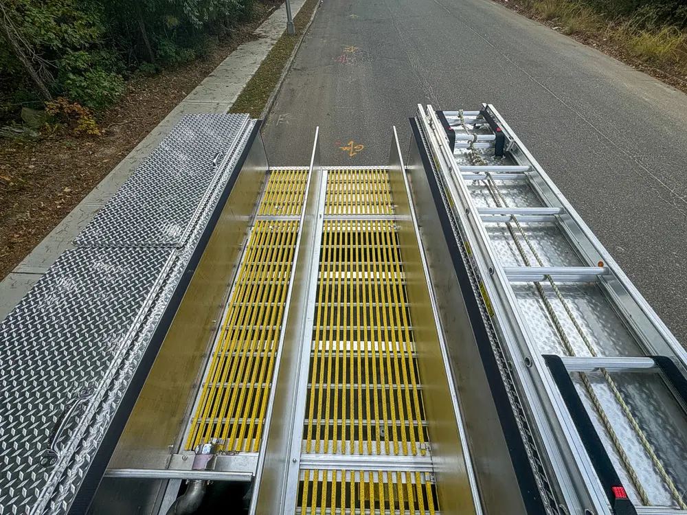 Top deck view along yellow grated walkway and side ladder.