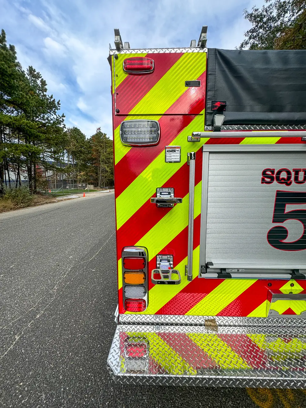 Rear-right panel close-up with Squad 5 roll-up door edge.