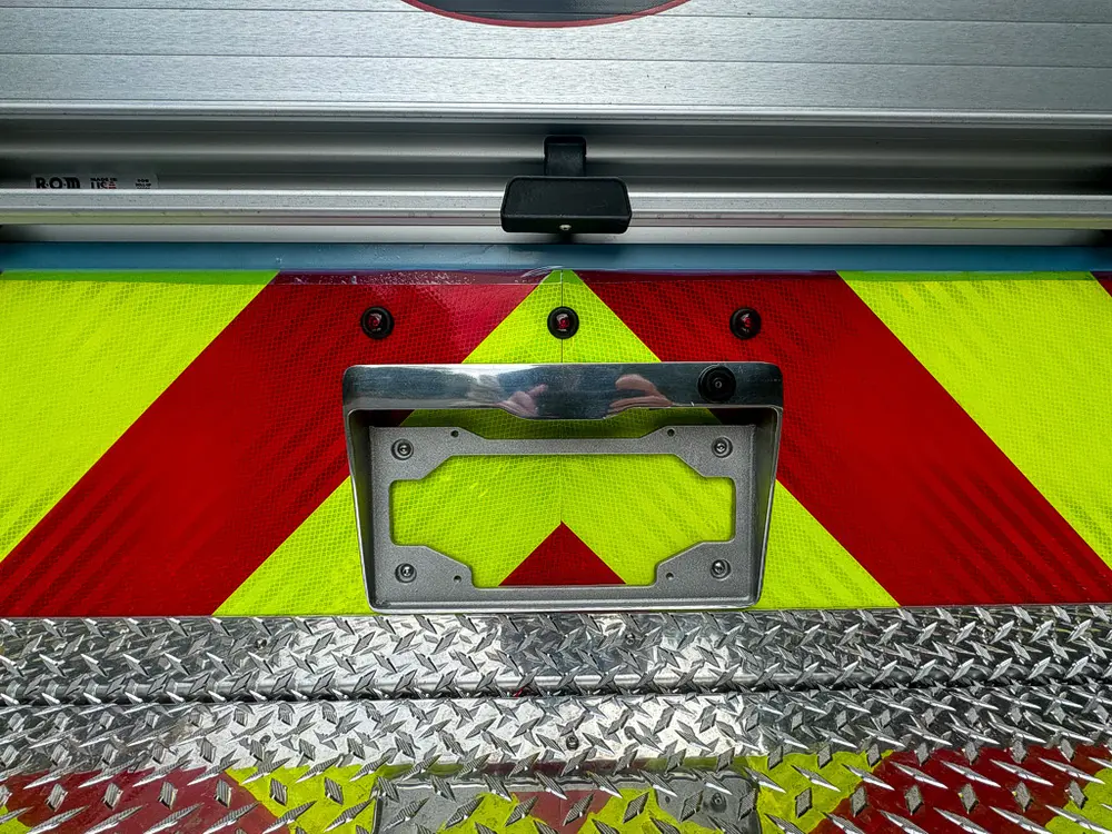 Rear bumper center close-up with license plate mounting recess.