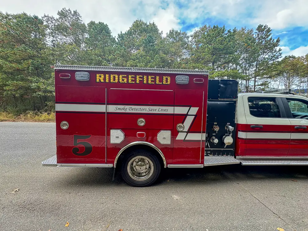 Right-side profile with large side compartment doors open.