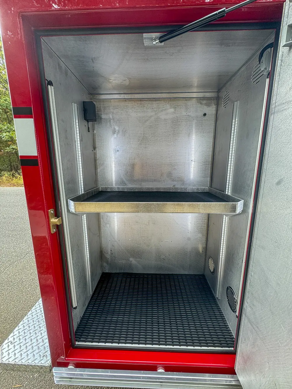 Open side compartment with shelf and empty interior bay.