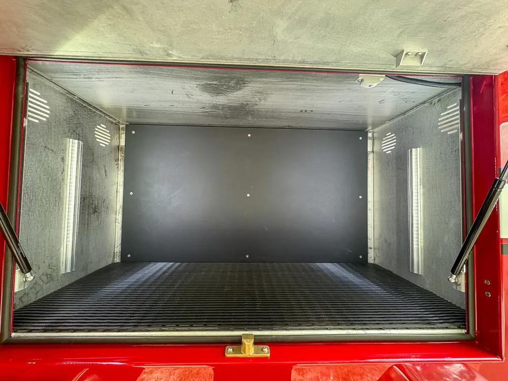 Open large side compartment showing broad empty storage floor.