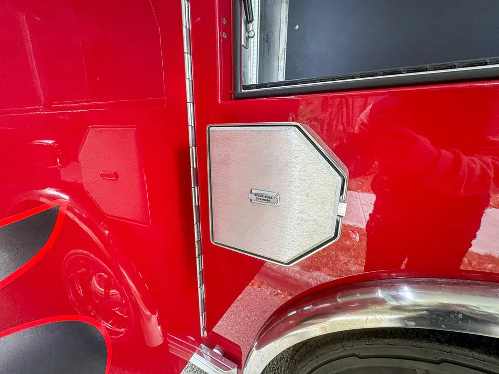 Lower side access hatch closed near wheel arch.