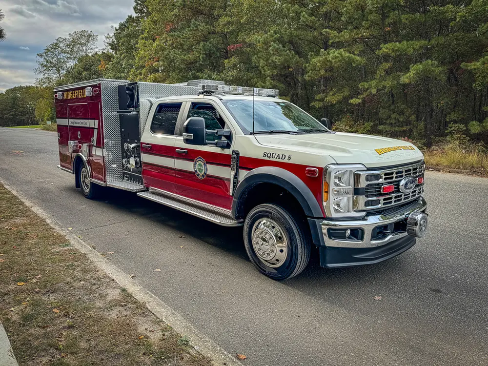 Front-left angle showing grille, cab, and body side.