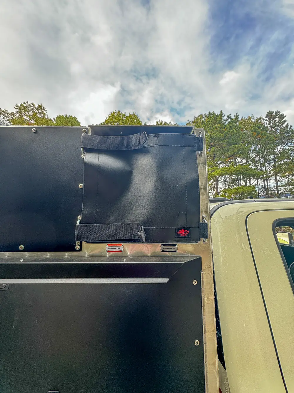 Open rear top-side compartment with black cover and deep bay.