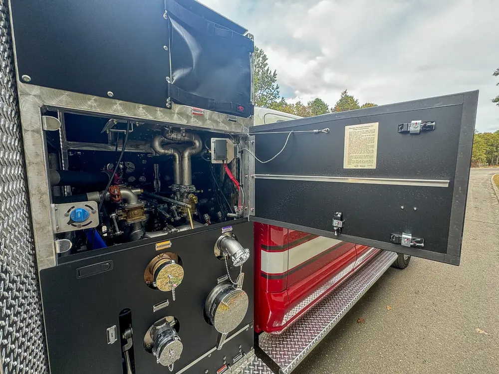 Open side pump compartment with valves and plumbing exposed.