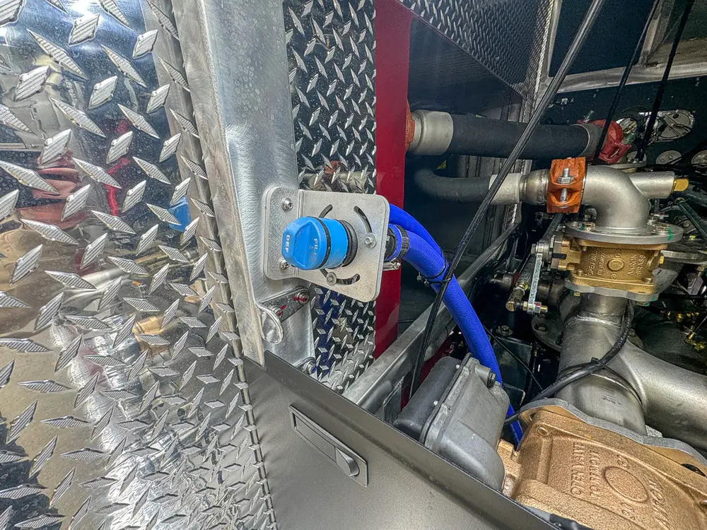 Side panel close-up with blue external connection fitting.