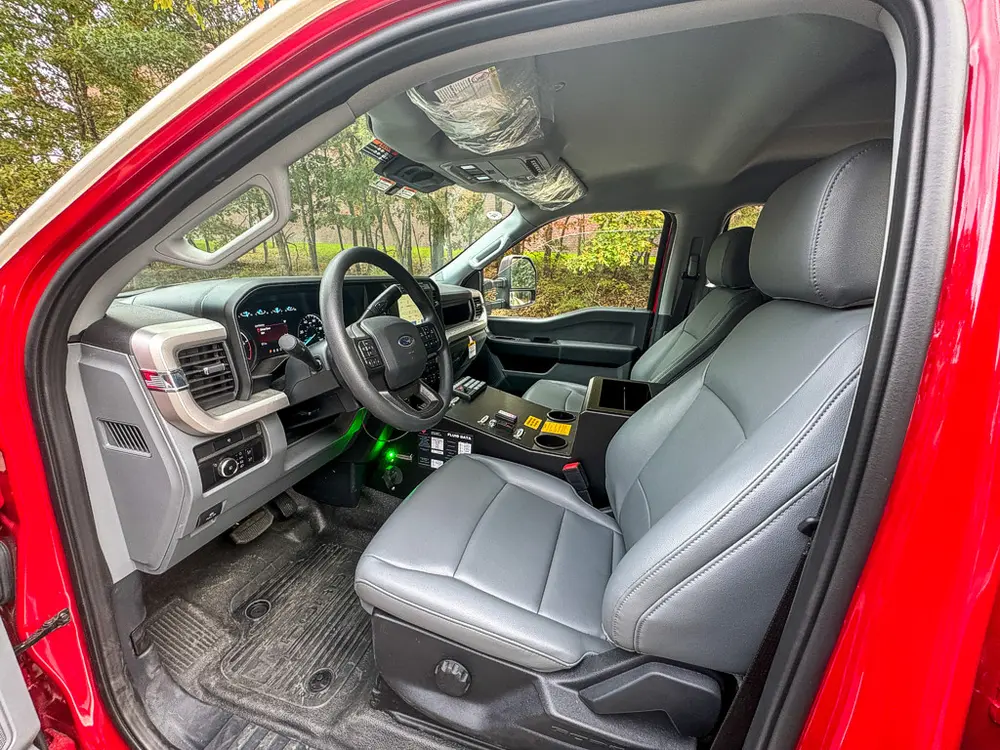 Front cabin interior view from driver side with dashboard and controls.