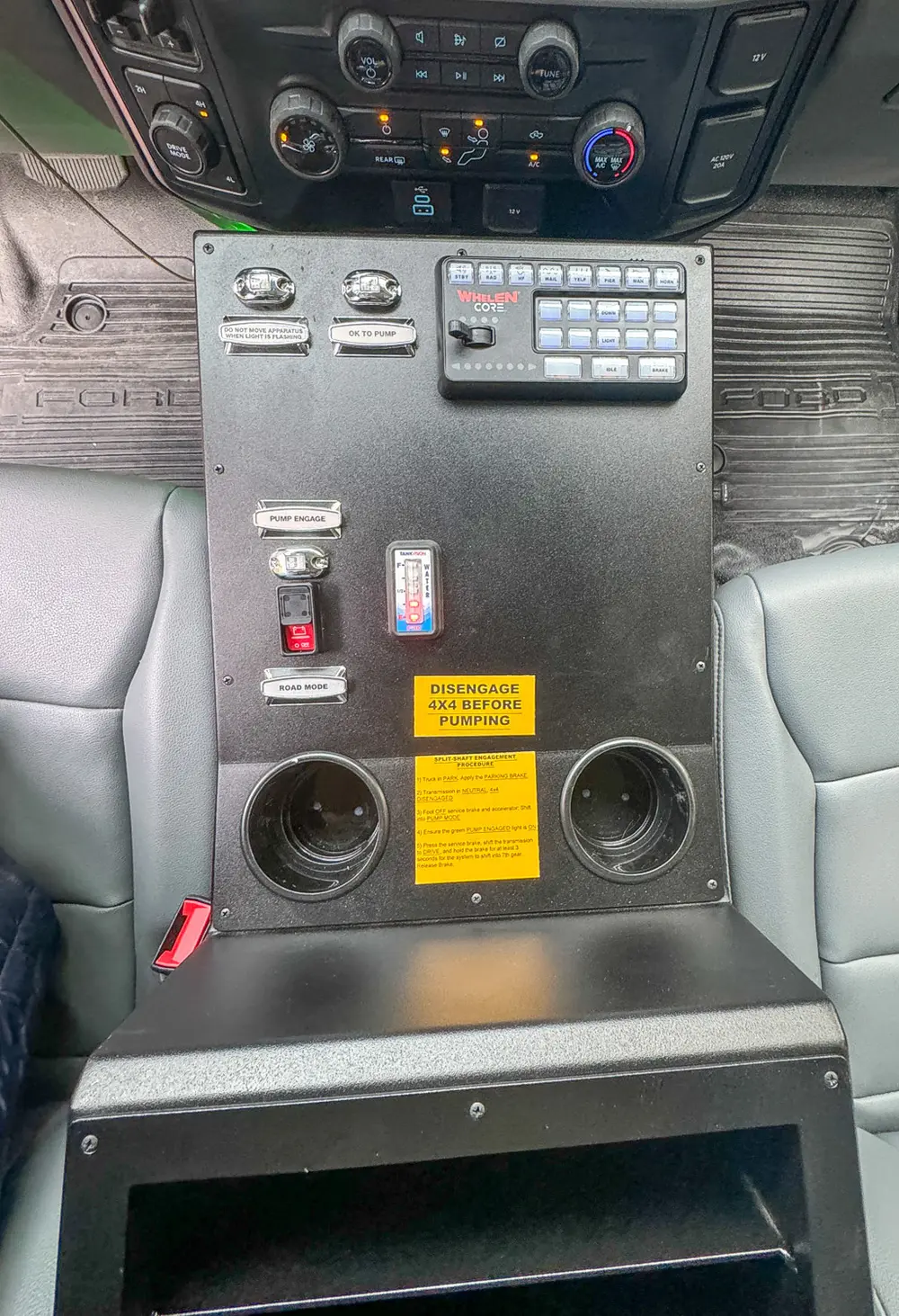 Center console controls and cup holder area close-up.