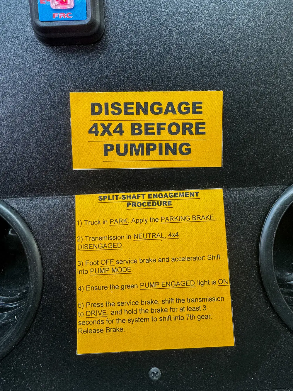 Yellow warning label close-up on center console.