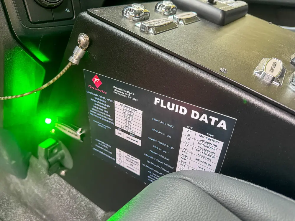 Passenger-side interior panel with fluid data placard and key switch.