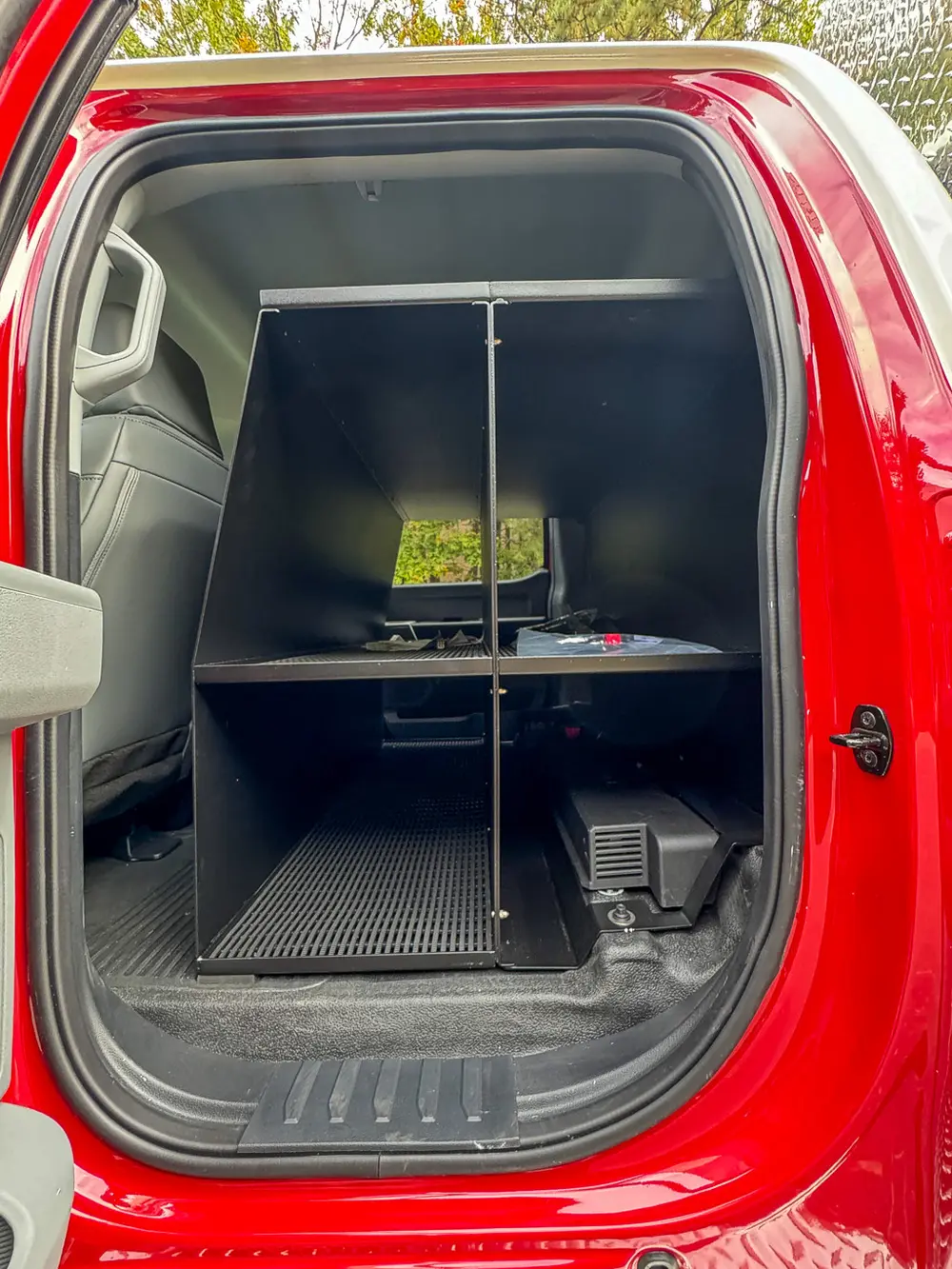 Rear cabin equipment cabinet with two shelves and mounted devices.