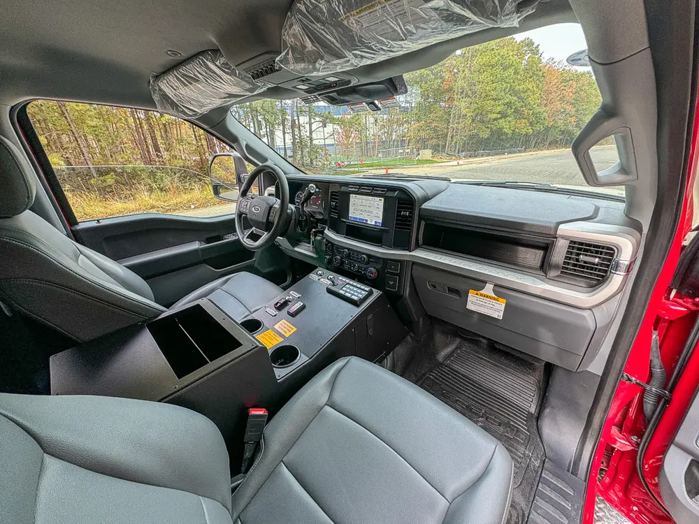 Front interior view from driver side showing dashboard and seats.