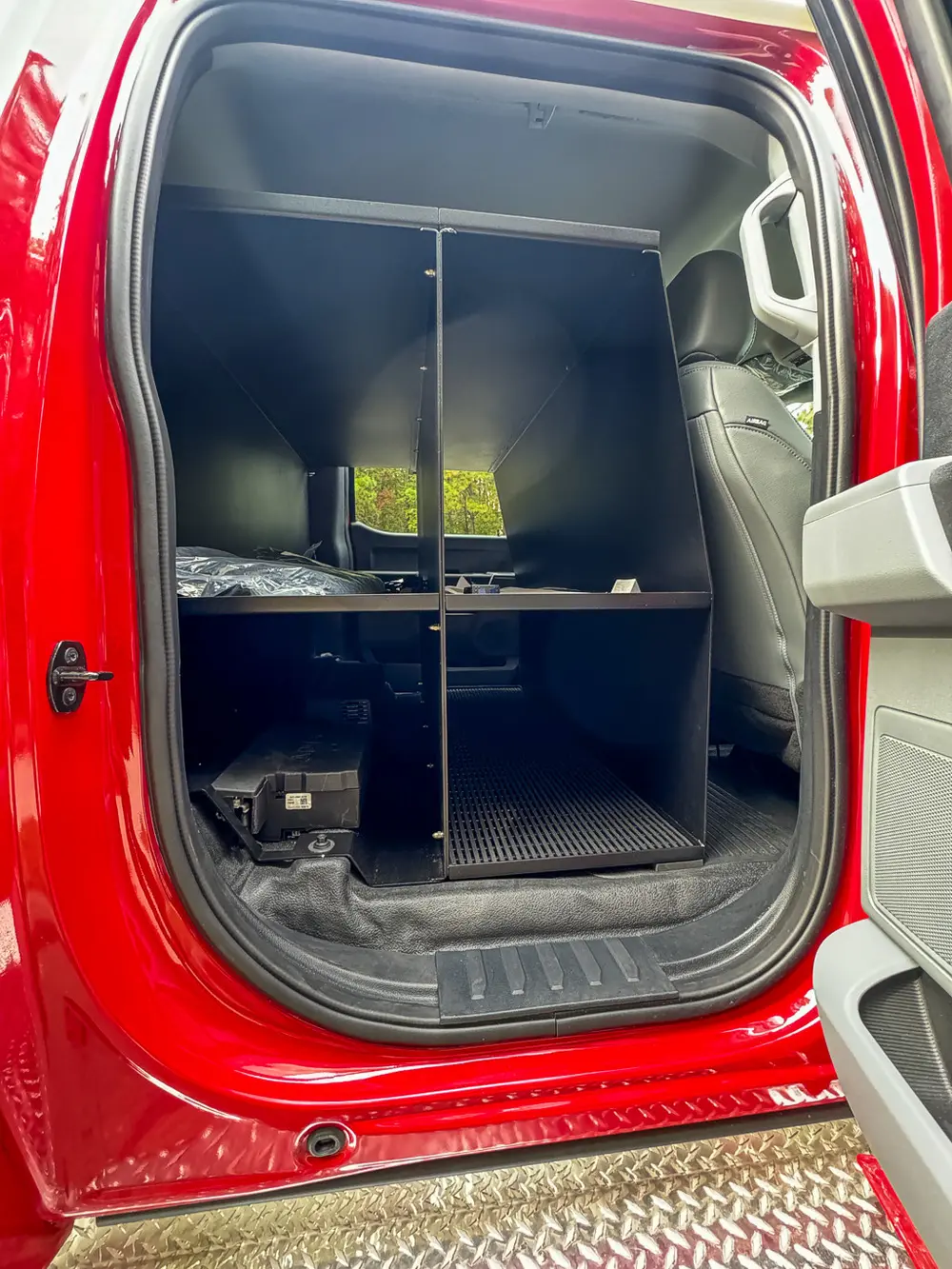 Rear equipment cabinet view from opposite side with shelves.