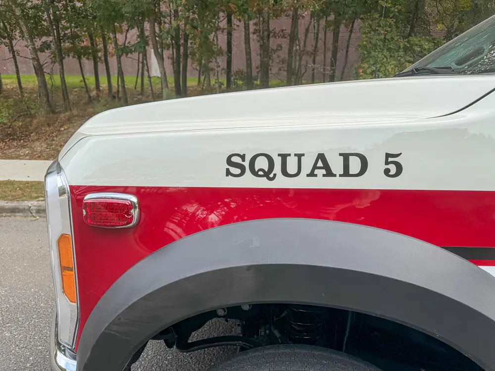 Rear fender close-up with Squad 5 lettering and panel seam.