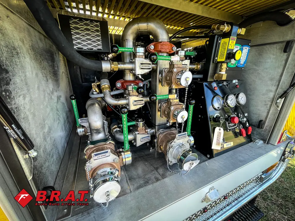 Exterior view of small fire truck showing cab, body compartments, and wheel/tire area.