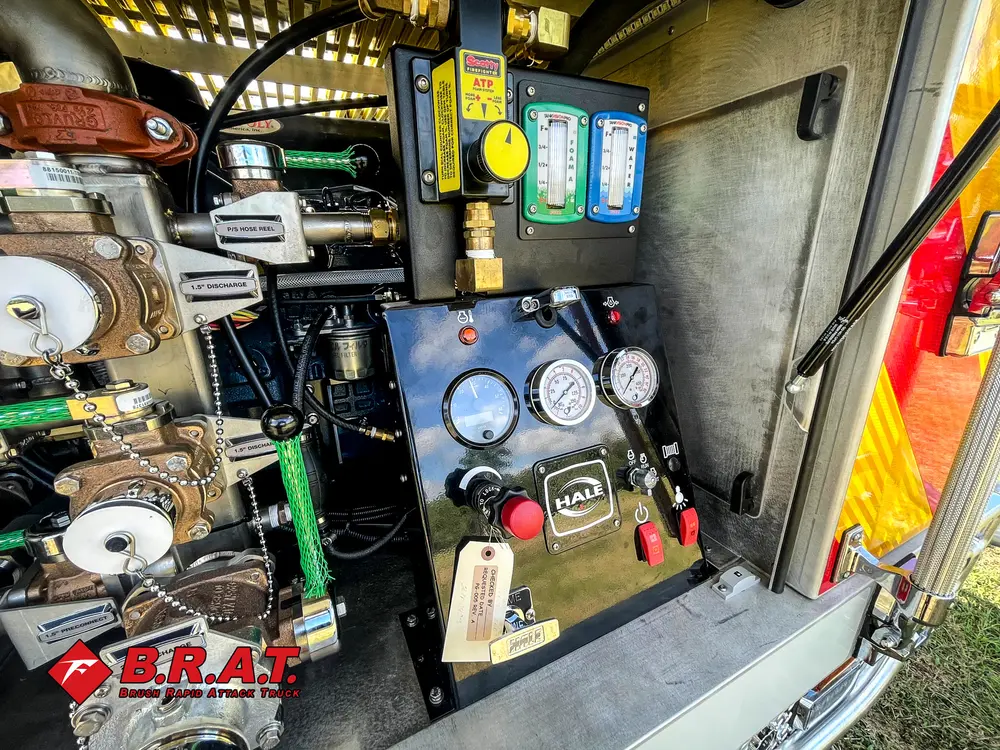 Exterior view of small fire truck showing cab, body compartments, and wheel/tire area.