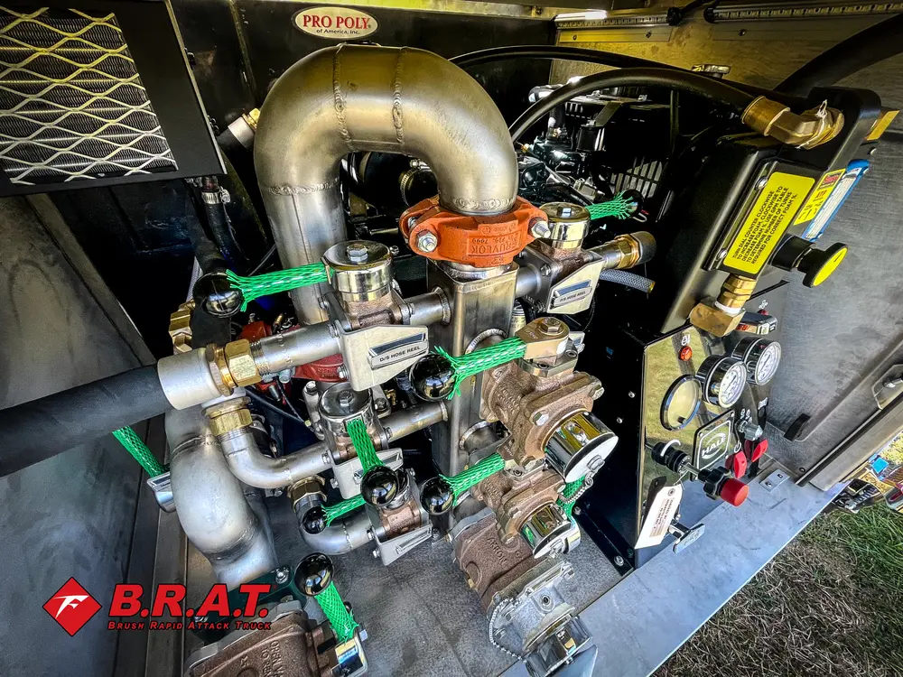 Exterior view of small fire truck showing cab, body compartments, and wheel/tire area.